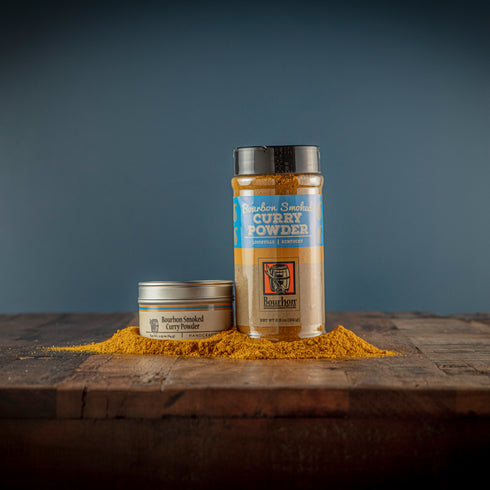 Bourbon Barrel Foods Smoked Curry Powder in a shaker and a tin.